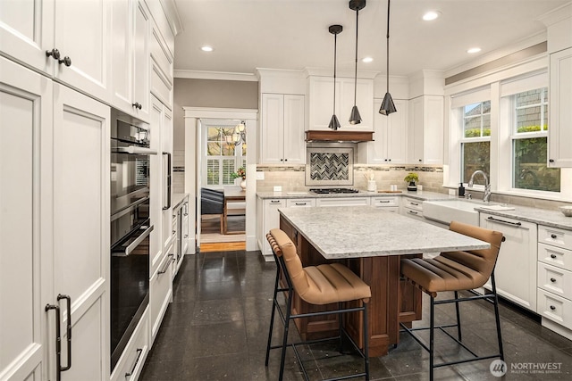 2311 42nd Ave E, Seattle, WA 98112 - kitchen with gas cooktop, ornamental molding, decorative backsplash, a sink, and white cabinets