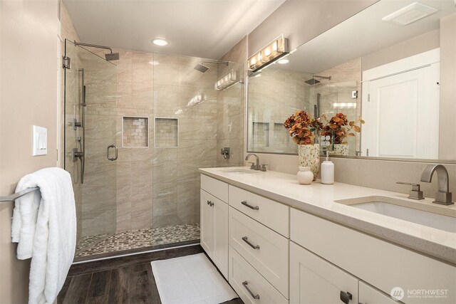 2311 42nd Ave E, Seattle, WA 98112 - bathroom with double vanity, a shower stall, wood finished floors, and a sink