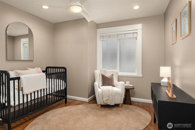2311 42nd Ave E, Seattle, WA 98112 - bedroom with a crib, baseboards, and wood finished floors