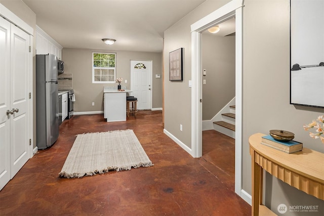 2311 42nd Ave E, Seattle, WA 98112 - interior space with finished concrete flooring, baseboards, light countertops, appliances with stainless steel finishes, and white cabinetry