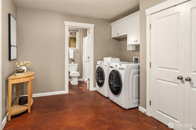 2311 42nd Ave E, Seattle, WA 98112 - clothes washing area featuring washer and clothes dryer, cabinet space, and baseboards