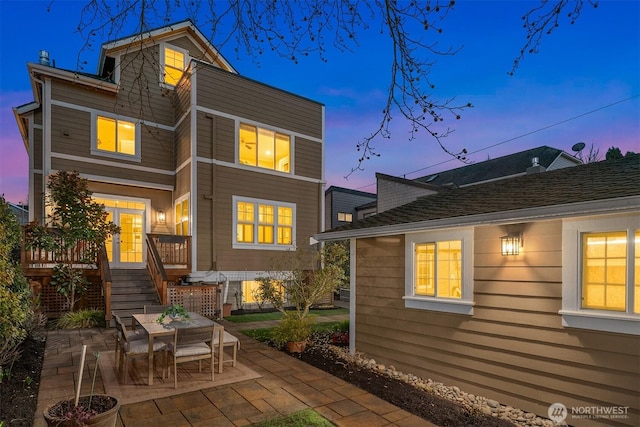 2311 42nd Ave E, Seattle, WA 98112 - back of property at dusk with a patio area and french doors