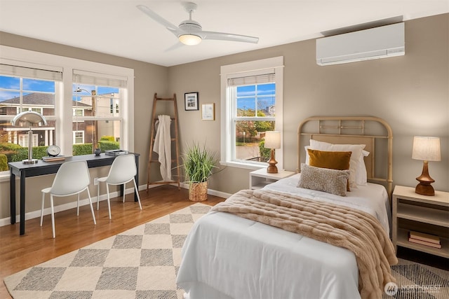 2311 42nd Ave E, Seattle, WA 98112 - bedroom featuring ceiling fan, wood finished floors, baseboards, and a wall mounted AC