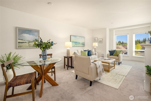 living area with visible vents and light colored carpet