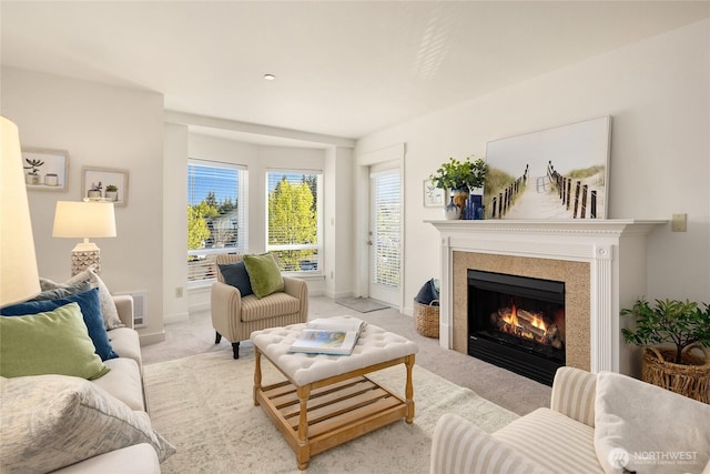 living room with light carpet, a lit fireplace, and baseboards