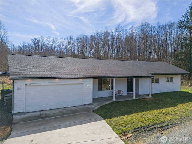 ranch-style home with driveway, a front lawn, roof with shingles, and an attached garage