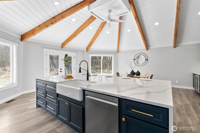 kitchen featuring dishwasher, a healthy amount of sunlight, a sink, and vaulted ceiling with beams