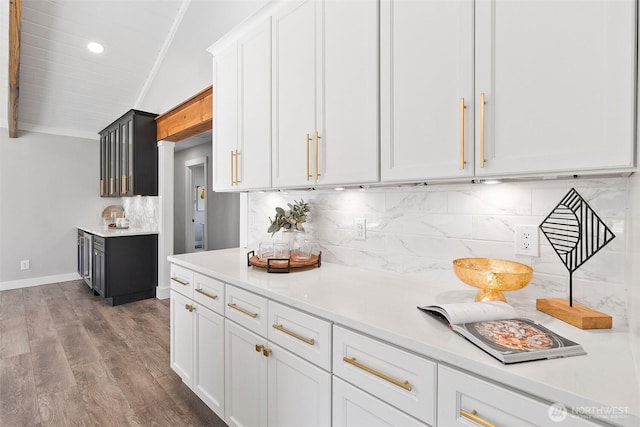 kitchen featuring tasteful backsplash, light countertops, and wood finished floors