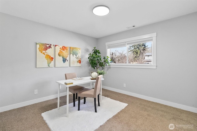 home office with carpet floors, baseboards, and visible vents