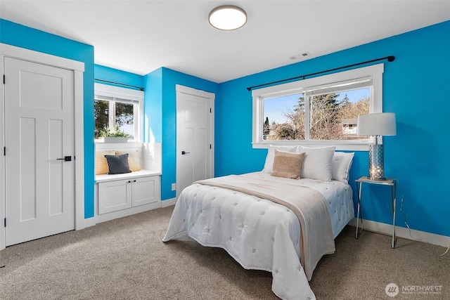 carpeted bedroom with baseboards and visible vents