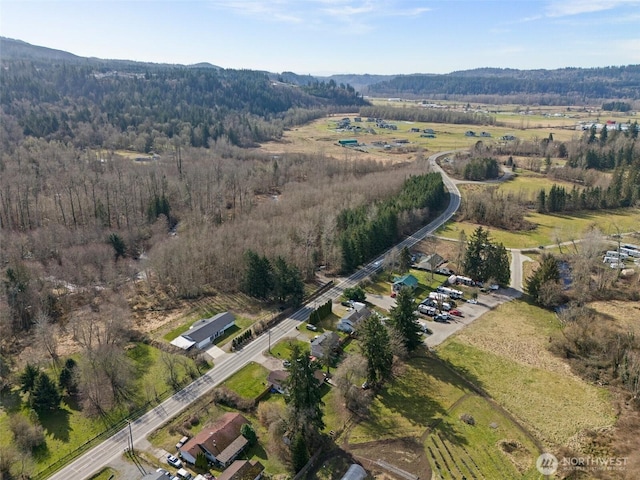 birds eye view of property with a forest view