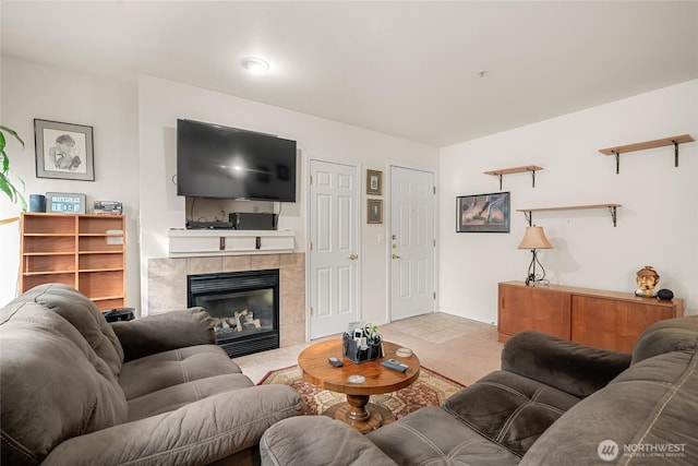 living room with light colored carpet and a tiled fireplace