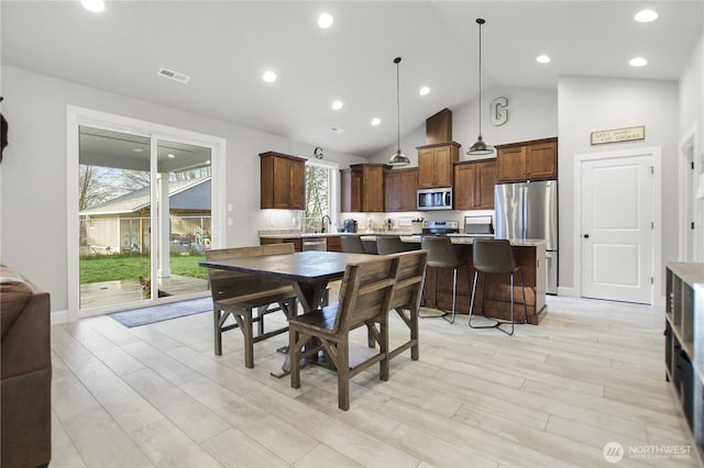 dining room featuring high vaulted ceiling, recessed lighting, visible vents, and light wood-style flooring