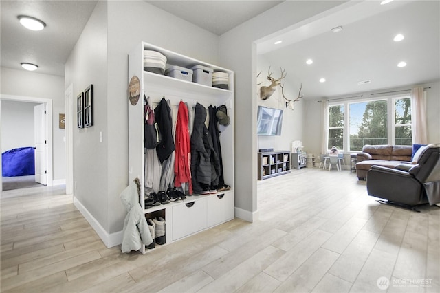 mudroom with baseboards, light wood finished floors, and recessed lighting