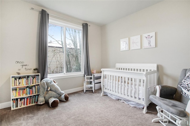 bedroom with a crib, carpet, and baseboards