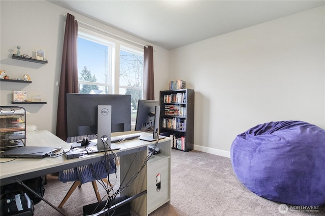 carpeted office space featuring baseboards