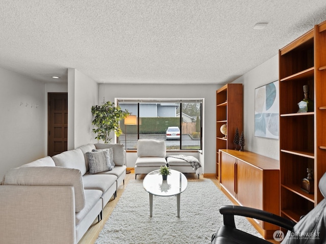 living area featuring a textured ceiling