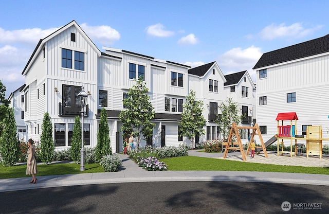 view of property with playground community, a residential view, board and batten siding, and a front yard