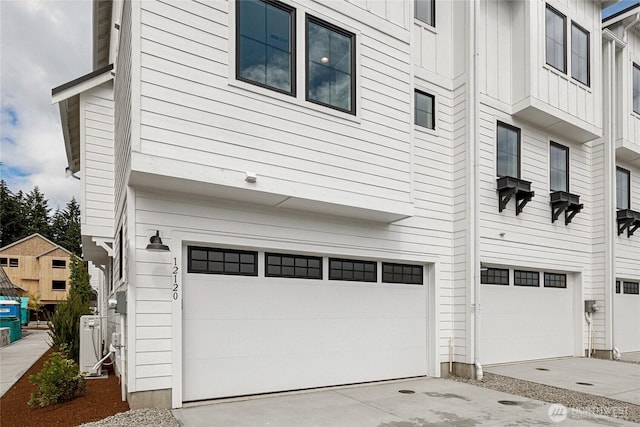 view of side of home featuring a garage and board and batten siding