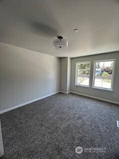 spare room with baseboards