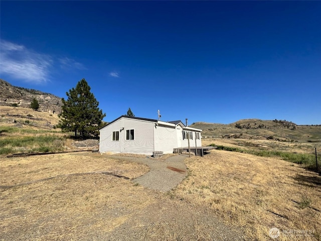 view of side of property with a mountain view