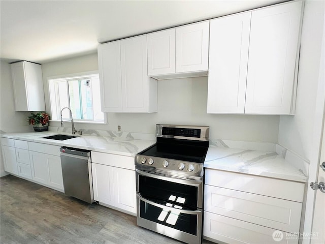 kitchen featuring white cabinetry, stainless steel appliances, and a sink