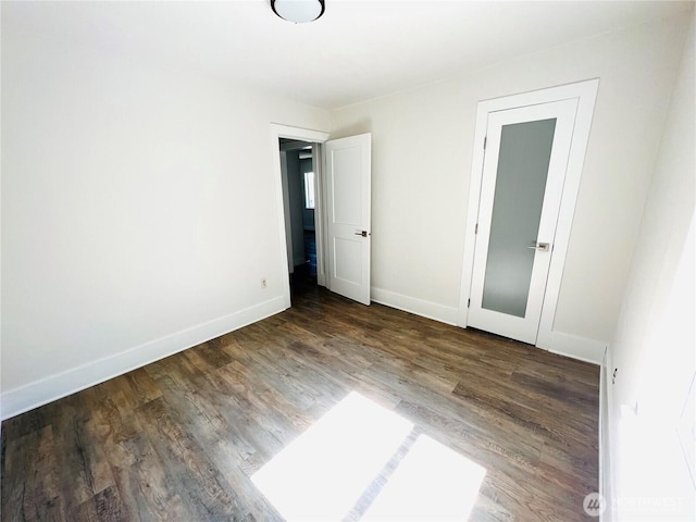 unfurnished bedroom featuring baseboards and wood finished floors