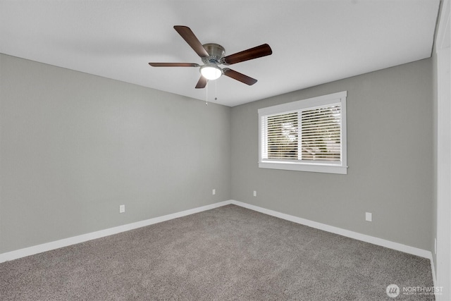 spare room with baseboards, carpet floors, and a ceiling fan