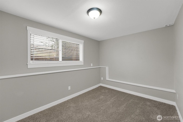 unfurnished room featuring baseboards and carpet flooring