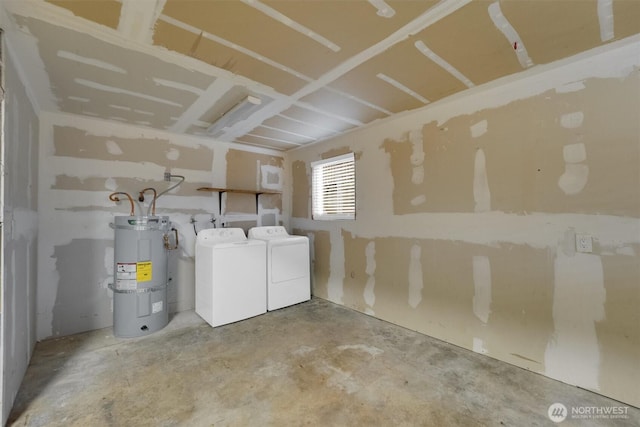 laundry area with water heater, washer and dryer, and laundry area