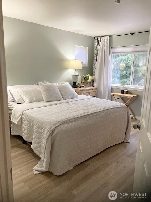 bedroom featuring light wood-style flooring