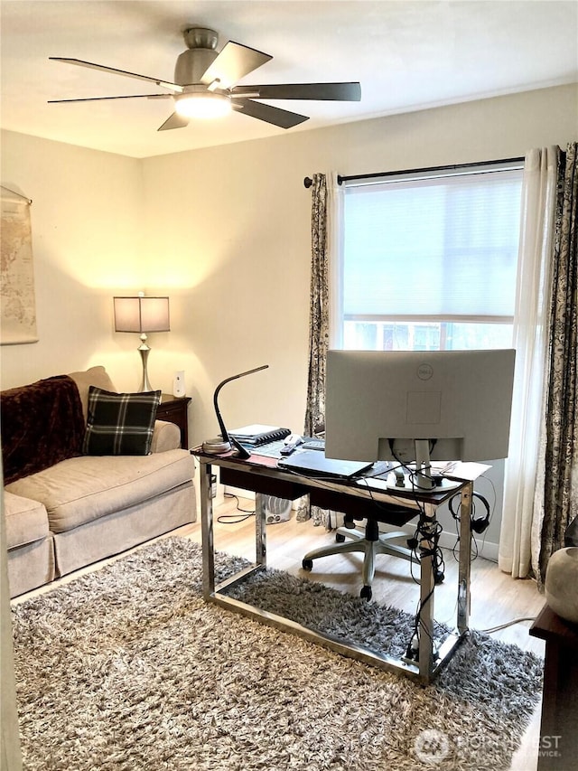 office with a ceiling fan and wood finished floors