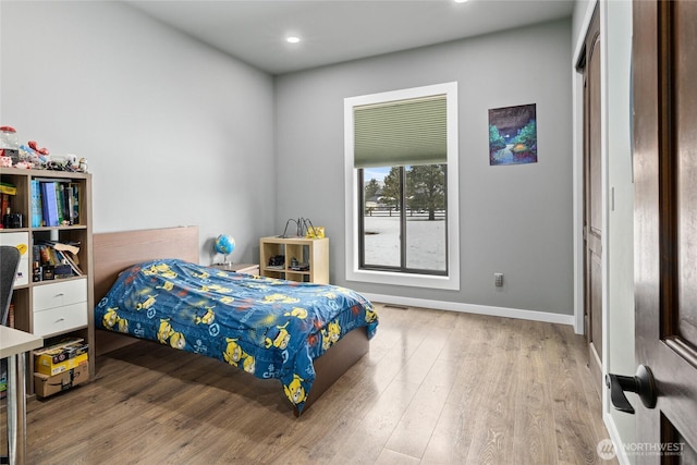 bedroom with recessed lighting, baseboards, and wood finished floors