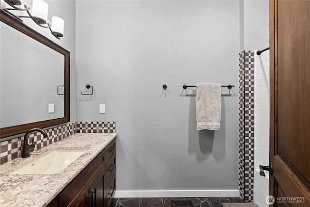 full bath with a shower with curtain, tasteful backsplash, baseboards, and vanity