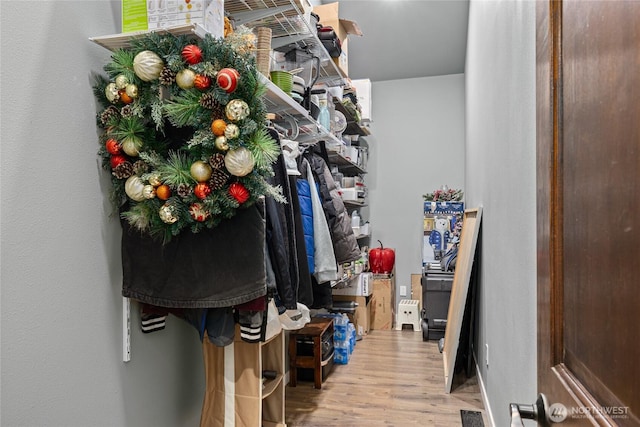 walk in closet featuring visible vents and wood finished floors