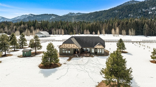 view of front facade with a mountain view and a view of trees