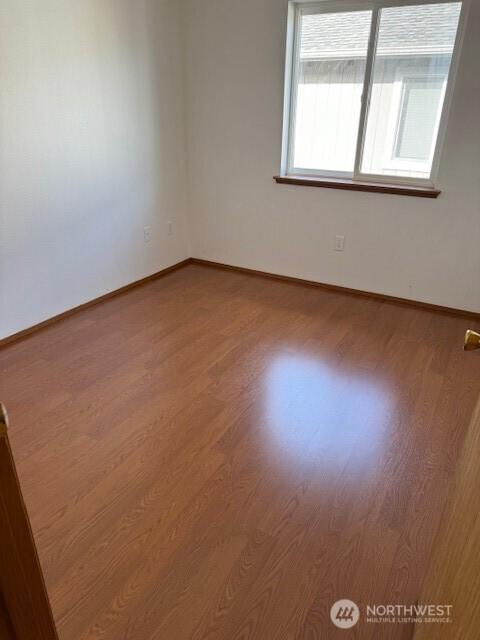 16081610 E 34th St Unit B, Tacoma, WA 98404 - empty room featuring baseboards and wood finished floors