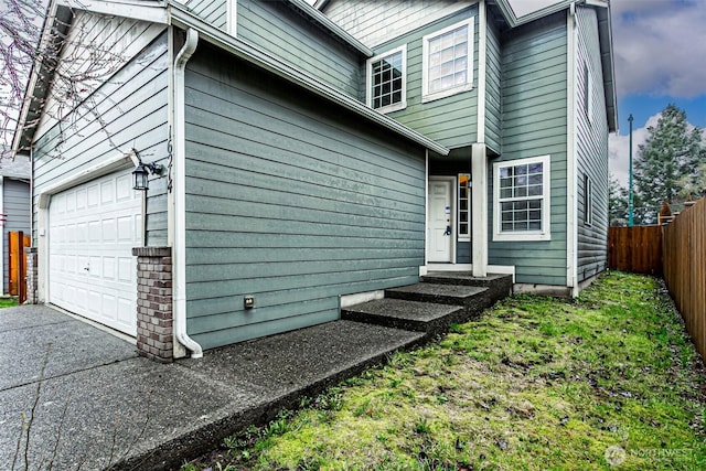 exterior space with a garage and fence