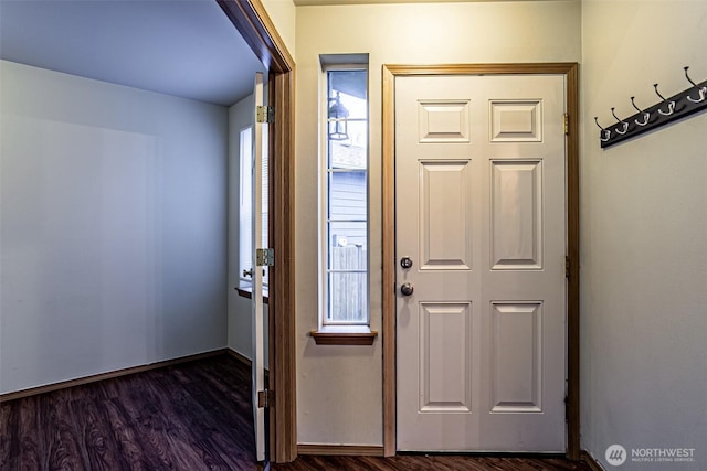 foyer featuring dark wood finished floors and baseboards