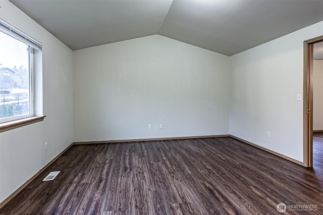 bonus room with lofted ceiling, dark wood-style flooring, visible vents, and baseboards