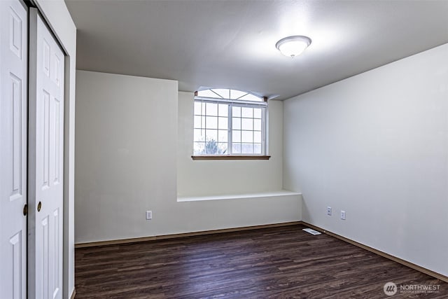 unfurnished bedroom with a closet, visible vents, and dark wood finished floors