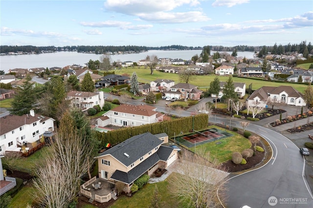 drone / aerial view featuring a residential view and a water view