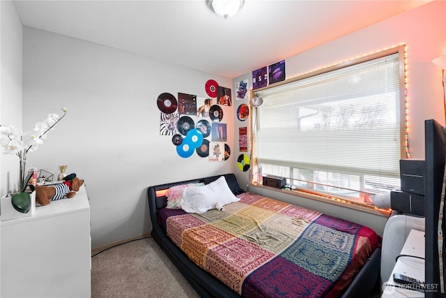 carpeted bedroom with baseboards