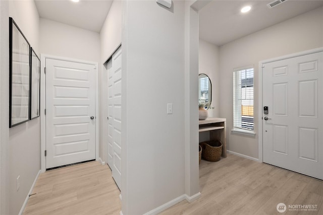 foyer entrance featuring light wood-type flooring, visible vents, baseboards, and recessed lighting