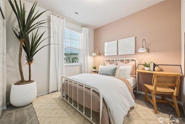 bedroom with visible vents and baseboards