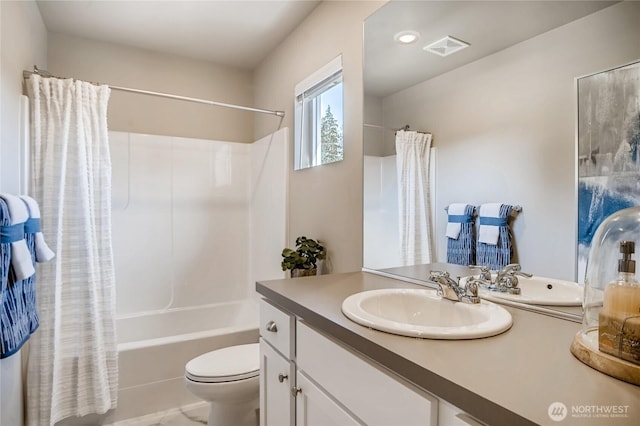 bathroom with toilet, shower / tub combo, visible vents, and vanity