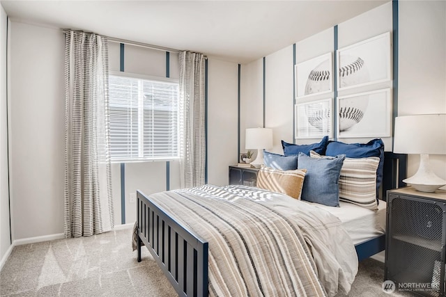 bedroom with light carpet and baseboards