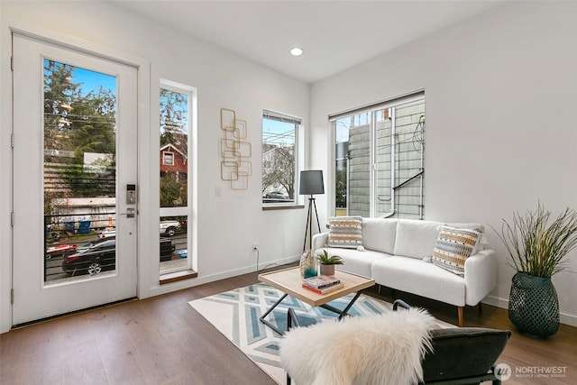 living area featuring recessed lighting, baseboards, and wood finished floors