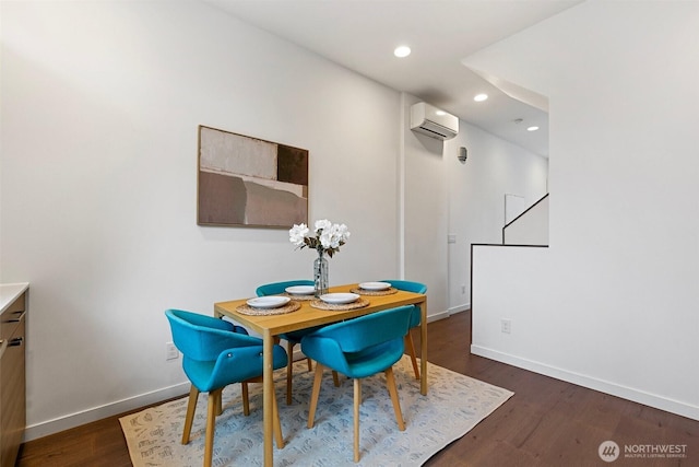 dining area featuring recessed lighting, dark wood-style flooring, a wall mounted air conditioner, and baseboards