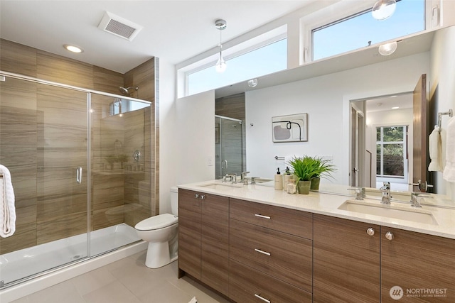 full bathroom with a stall shower, a sink, and visible vents